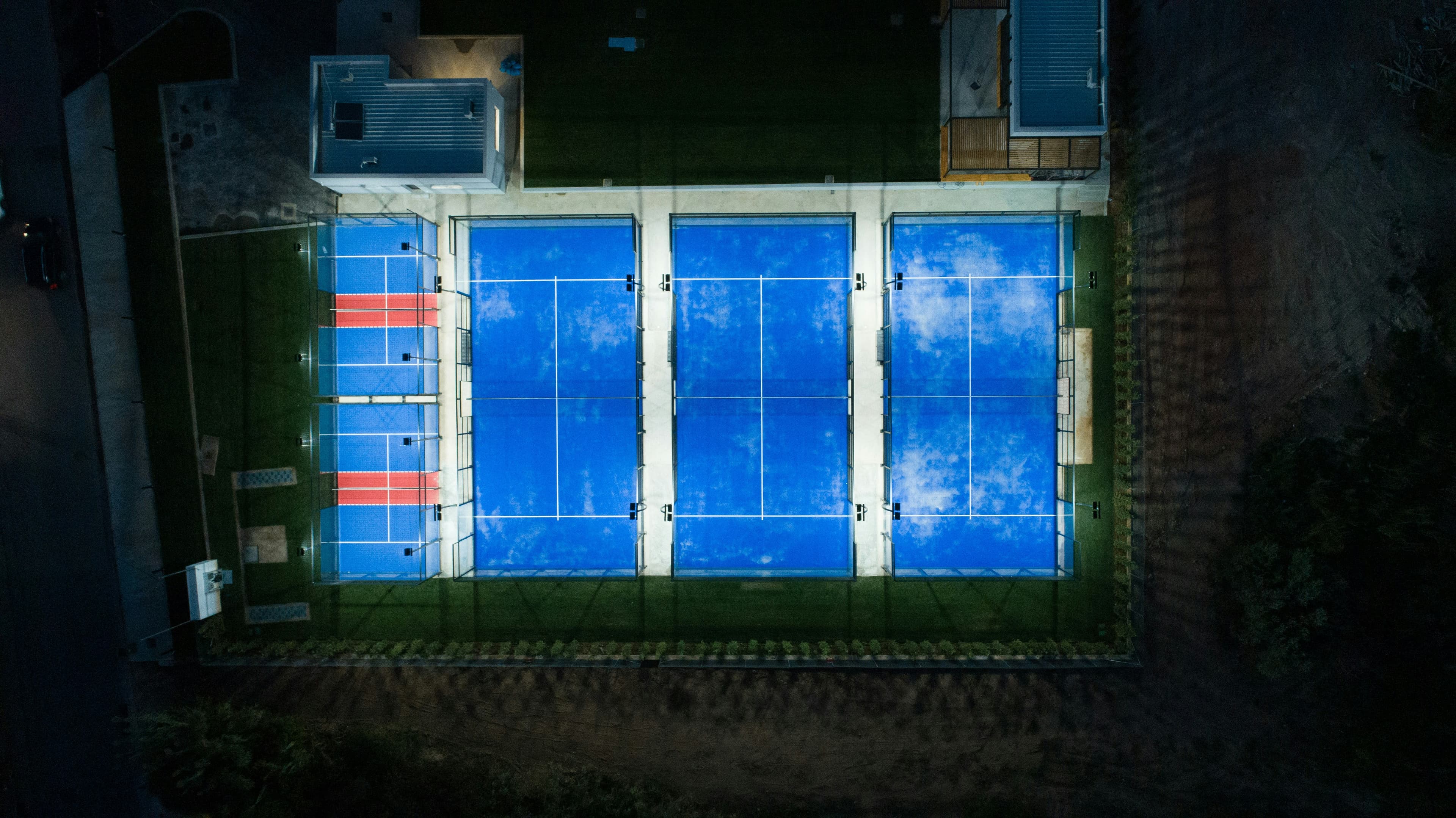 Aerial view of multiple illuminated padel courts